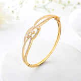 Sparkling Elegance Twilight Interlace Gold American Diamond Bracelet